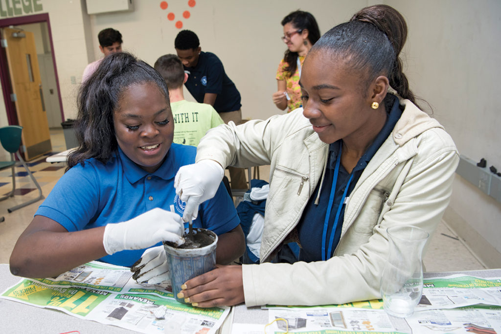 Teaching Teams from the Young Scientist Program (YSP) lead hands-on demonstrations in area classrooms. Vashon High School students build a Winogradsky column — a soil layer cake — during a presentation on ecology and evolution. 